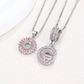 Pink zircon initial G pendant necklaces featuring 3D iced out and sunburst floral designs - Silver G