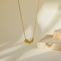 Elegant gold titanium necklace featuring gradient polished beads on a delicate chain - Gold Gradient Five-Bead Style (HC392)