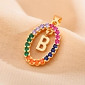 Detailed close-up of a gold oval pendant with colorful rhinestones and letter B - Letter B