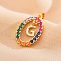 Detailed macro view of a gold letter G pendant with multi-color cubic zirconia stones - Letter G