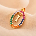 Macro shot of gold oval pendant with rainbow zircon stones and letter I detail - Letter I