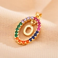 Detailed close-up of letter O pendant with colorful zircon stones on gold-plated chain - Letter O