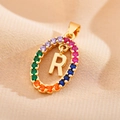 Macro shot of gold oval pendant featuring a letter R with colorful zircon pave stones - Letter R