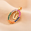 Macro view of gold plated necklace with letter U pendant and colorful zircons - Letter U