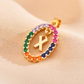 Detailed macro of gold oval pendant with colorful zircons and central letter X design - Letter X
