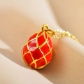 Elegant gold-plated red enamel egg pendant necklace with intricate diamond lattice design - Red