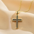 Macro shot of gold-plated cross pendant featuring black micro-pave cubic zirconia inlay - Black