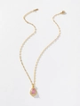Detailed shot of pear-cut pink gemstone pendant with gold chain on white background - Pink