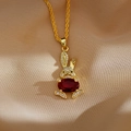 Detail van een gouden konijn-hanger met een rode edelsteen en ingelegde zirkonia-kristallen - Rood