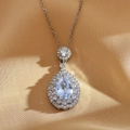 Macro detail of teardrop light blue gemstone pendant with double diamond halo on silver chain - Light Blue