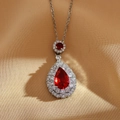 Silver titanium steel necklace with a teardrop ruby pendant surrounded by double diamonds - Red