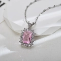 Macro shot of rectangular pink zircon pendant with halo setting on silver chain - Silver Pink Necklace