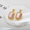 Close-up of elegant gold earrings with rectangular pink zircon and halo diamonds - Gold Pink Stud Earrings