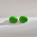 Elegant oval neon green freshwater pearl stud earrings on white textured background - Green