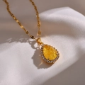 Elegante gouden druppelvormige ketting met gele kristal en micro-gezette zirkonia - Geel