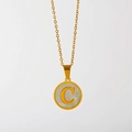 Detail of gold necklace with white shell round pendant featuring letter C engraving - English Letter C (X029-C)
