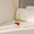 Macro shot of 18K gold cherry earrings with red stones and size dimension markings - Necklace