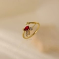 Detailed macro view of an open ring with gold leaves and red pear-cut zircon stone - Red Drop Leaf Style (JZ004-3)
