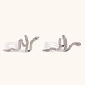 Macro shot of silver snake-shaped ear cuffs with realistic scale texture and metallic finish - Steel