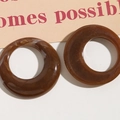 Close-up of brown resin hoop charms with marble texture and high gloss finish - Coffee Marble Pattern
