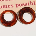 Detailed view of resin hoop earrings with vintage amber and tortoiseshell pattern finish - Amber Tortoiseshell