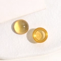 Macro shot of 14mm translucent amber resin cabochons with smooth polished finish - 1 Piece / Transparent Yellow
