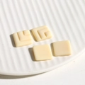 Macro detail of creamy white geometric resin square charms for DIY earring and jewelry crafts - Square / White