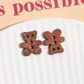 Close-up of bear-shaped wooden buttons with natural grain for DIY craft accessories - Brown Bear