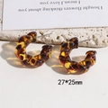 Macro view of leopard print resin C-shape earrings with size dimensions 27x25mm - 27x25mm