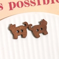 Macro shot of cat-shaped wooden buttons with natural wood grain on a white ceramic tray - Brown Cat
