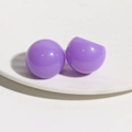 Close-up of glossy purple resin spherical DIY hair clip accessories on white base - Purple