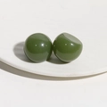 Detail of dark green resin dome studs with a glossy finish for DIY hair accessories - Green