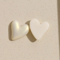 Close-up of pearl and matte white heart-shaped acrylic DIY accessories for jewelry - White