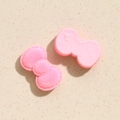 Détail d'un nœud floqué rose pour DIY montrant la texture velours et le dos lisse - Rose