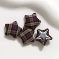Detail of star shaped fabric buttons with purple plaid pattern on white background - Purple