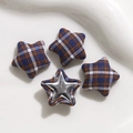 Macro view of star-shaped fabric plaid buttons and metal star decorative accessories - Blue