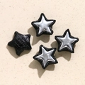 Macro shot of star-shaped snake pattern leather charms for DIY jewelry and clothing accessories - Black