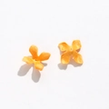 Close-up of handmade orange fabric osmanthus petals with center hole for DIY jewelry - Yellow