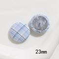 Detailed view of 23mm blue gingham fabric covered buttons with silver metal back - Large Round Style / Blue