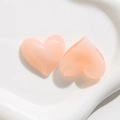 Close-up of heart-shaped acrylic charms for DIY hair clips and phone case crafts - Pink