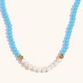Close-up of sky blue faceted beads and natural freshwater pearls on 18K gold necklace - Sea Blue Jade Texture