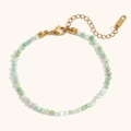 Macro detail of 18K gold plated beaded bracelet with light green and white natural stones - Green Synthetic Opal