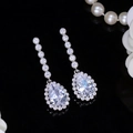 Macro view of silver teardrop earrings with AAA cubic zirconia and pear-cut design - White