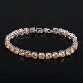 Macro detail of silver tennis bracelet featuring AAA champagne cubic zirconia stones - Champagne (18cm)