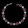 Detail of elegant zircon bracelet with red round stones and silver clover accents - Red