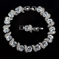 Macro shot of silver bracelet showing large oval zircon stones and intricate micro-pave setting - White