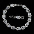 Macro detail of silver bracelet featuring leaf-shaped links and AAA cubic zirconia stones - White