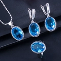 Detailed view of elegant jewelry set with oval sapphire blue stones and silver metal - US 6 / Aquamarine