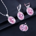Close-up of pink oval zircon jewelry set with silver necklace earrings and ring details - Pink