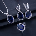 Detail of jewelry set with oval dark blue stones and beaded silver edges on dark background - Dark Blue